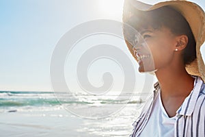 Live in the sunshine. a young woman enjoying a day at the beach.
