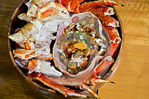 Live TARABA King Crab steamed on wooden tray. Legs and claws were cut into pieces. Taraba fried rice are in the crab shell