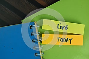 Live Today write on sticky notes write on a sticky notes isolated on Wooden Table