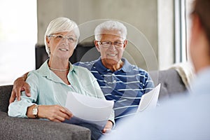 Live for tomorrow. Over-the-shoulder shot of a financial advisor meeting with a senior couple at their home.