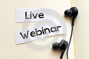 LIVE WEBINAR word written on a white sheet of paper placed on a notepad