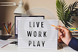 Live Work Play concepts with text on light box on desk table in home office.Life balance.positive emotion