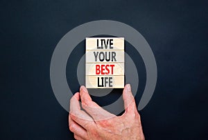 Live your best life symbol. Concept words Live your best life on wooden blocks. Beautiful black table black background.
