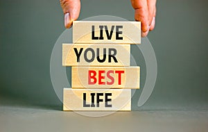 Live your best life symbol. Concept words Live your best life on wooden blocks. Beautiful grey table grey background. Businessman