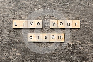 live your dream word written on wood block. live your dream text on cement table for your desing, concept
