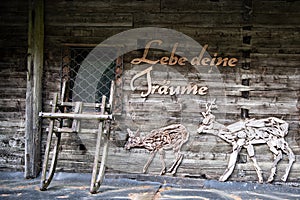 `Live your dreams` - a wooden fascade with a slogan and  a couple of deers
