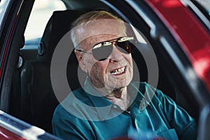 Live your life and forget your age. a senior man driving his car.