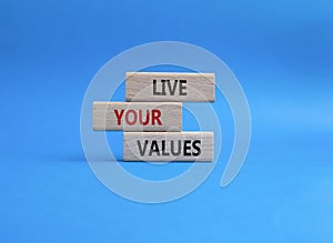 Live your values symbol. Concept words Live your values on wooden blocks. Beautiful blue background. Business and Live your values