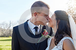 And so they lived happily every after. a bride and groom kissing on their wedding day.