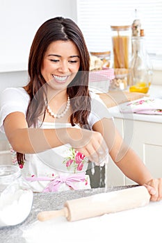 Lively asian woman baking in the kitchen photo