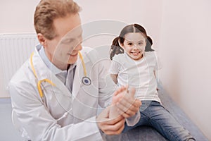 Lively charismatic child having her feet treated