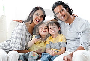 Lively family watching TV together