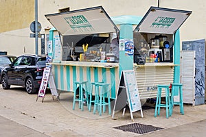 A lively food truck serving delicious dishes on a bustling street