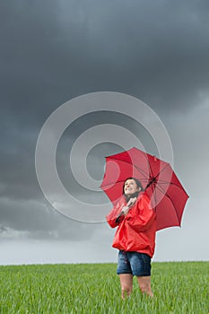 Lively girl daydreaming on rainy day photo