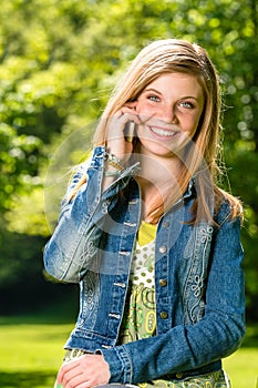 Lively young girl talking on her phone