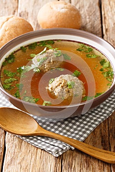 Liver Dumplings are a traditional Bavarian dish severd in a hot brooth close-up in a plate. Vertical