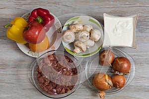 Liver and mushrooms for stewing in vegetables. Culinary background with selective focus