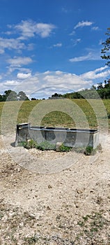 Livestock water trough in field.