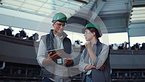 Livestock workers checking production facility. Automated equipment milk farm.