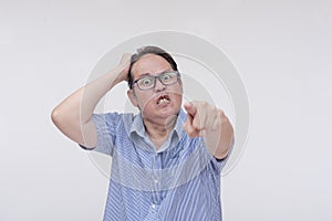 A livid and vengeful man issuing a threatening warning. Seething with extreme anger. Isolated on a white background photo