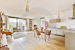 a living area with a dining table and a kitchen