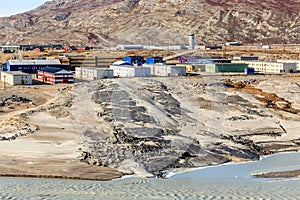 Living blocks on the hill above muddy melted glacier river with