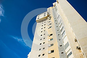 Living building common modern architecture exterior facade foreshortening from below on vivid blue sky background