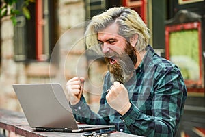 Living in digital age. Freelancer man working on computer. Businessman using notebook and phone. Escaped of office