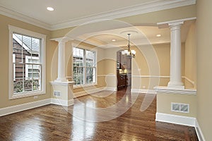 Living and dining room with white pillars