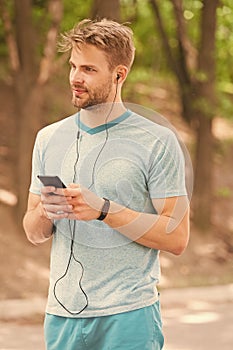 Living a mobile lifestyle. Athletic man tracking his activity with mobile phone app. Sportsman using mobile device and