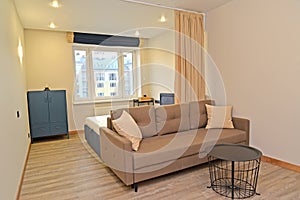 Living room-bedroom with metal coffee table. Residential zoning photo
