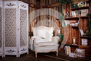 Living room with beige chair and bookcase