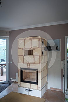 In a living room is built a tiled stove