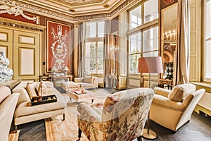 the living room is decorated with gold and white furniture