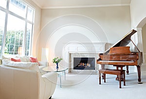 Living room decorated with leather sofa and piano with burning f