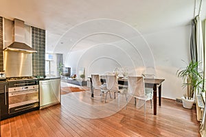 a living room with a dining table and a kitchen