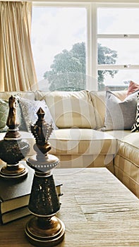 The living room is dominated by beige striped sofas.