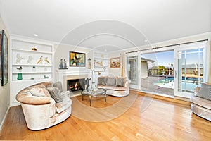 Living room with a fireplace, sofas, and TV in Encino, CA