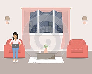 Living room with furniture on the window background. In the armchair is a young woman with a laptop