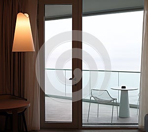 Living room with glass door to balcony. Sea view photo