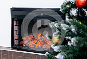 Living room home interior with decorated fireplace and christmas tree