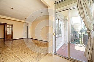 Living room of a house with access to a terrace with terracotta floors and aluminum and glass sliding doors