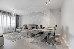 Living room of a house with gray wooden dining table with matching chairs