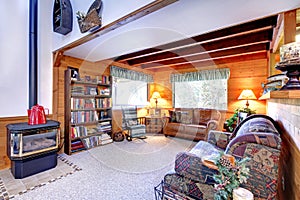 Living room interior with antique fireplace in log cabin house