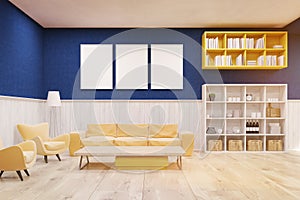 Living room interior with blue and white walls, wooden floor and large sofa.