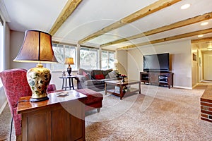 Living room interior with brick fireplace, wood beams and red.