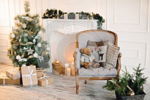 Living room interior for Christmas, with a decorated Christmas tree, fireplace and candles.