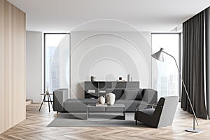 Living room interior with empty white wall, large grey sofa