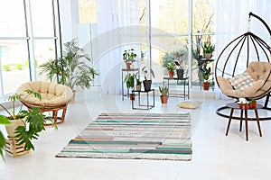 Living room interior with indoor plants, swing and papasan chairs