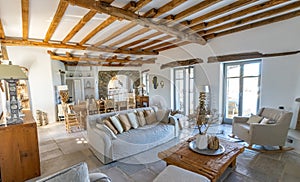 Living room interior with natural stone tiles floors and visible beam in new luxury home